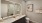 bathroom with two sinks and backlit mirrors
