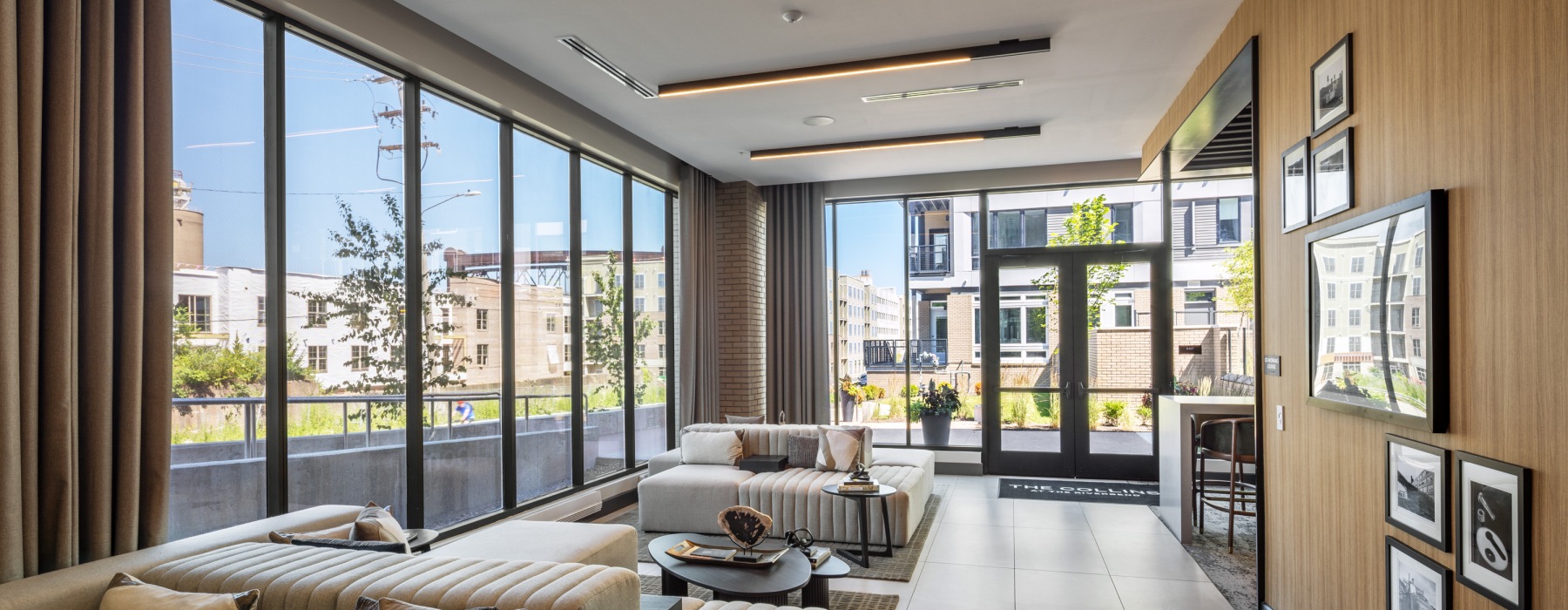 a room with couches and large windows