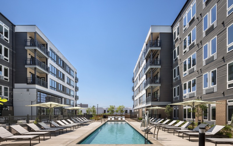 a pool in a courtyard between buildings