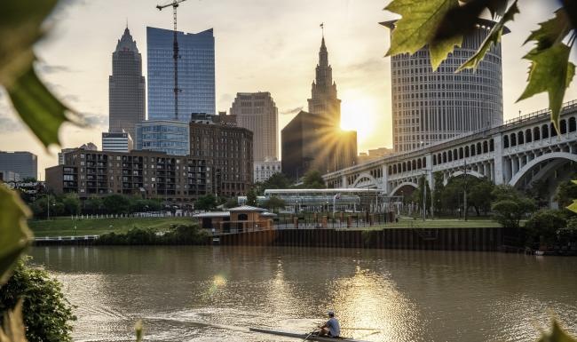 A beautiful community at the heart of all your passions a person in a body of water with a city in the background